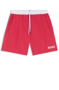 Badeshorts mit kontrastfarbenem Logo und Paspelierung