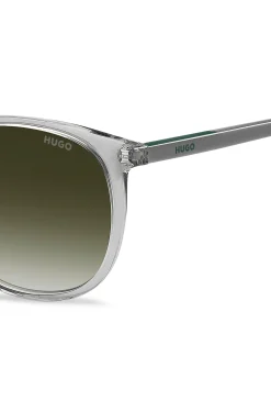 Transparent-graue Sonnenbrille mit grünem Logo